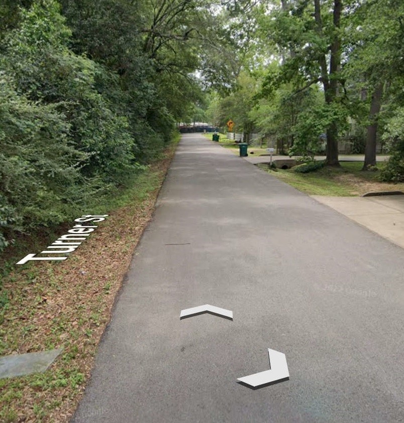 705 North 6th Street Conroe, TX 77301 - Photo 7 of 8 a view of a street with trees on both side of it