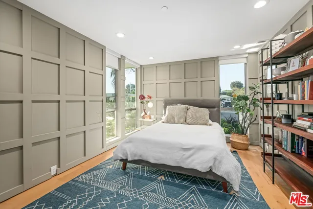 a bedroom with a bed furniture and a book shelf