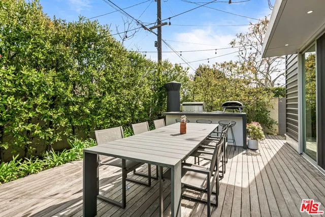 a view of a patio with a table and chairs and potted plants