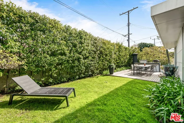 a view of a house with backyard porch and sitting area