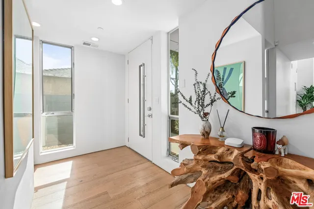 a view of a livingroom with furniture and a mirror