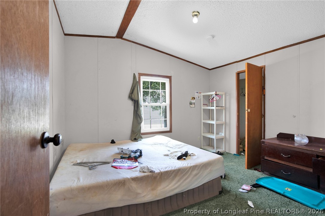 4705 Hickory Ridge Road Parkton, NC 28371 - Photo 26 of 37 a bedroom with a bed and a dresser