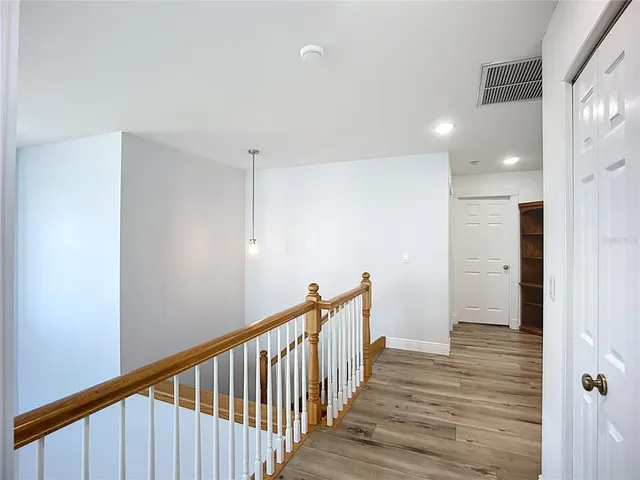 a view of hallway with wooden floor