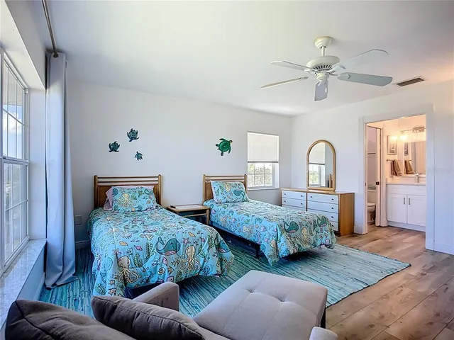 a bedroom with two beds and painted walls