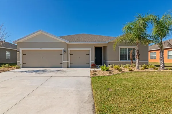 a front view of a house with a yard and garage