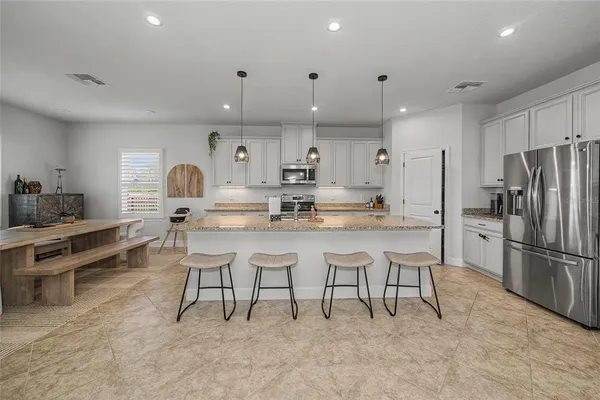 a kitchen with center island and stainless steel appliances