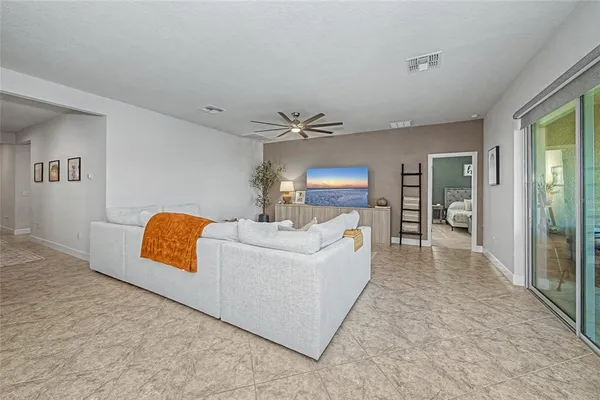 a living room with furniture and kitchen view