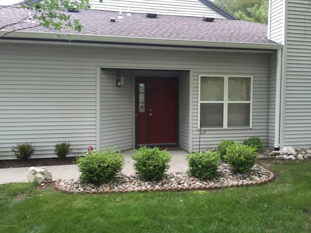 a view of a house with a yard and plants