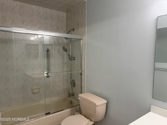 a bathroom with a toilet and shower