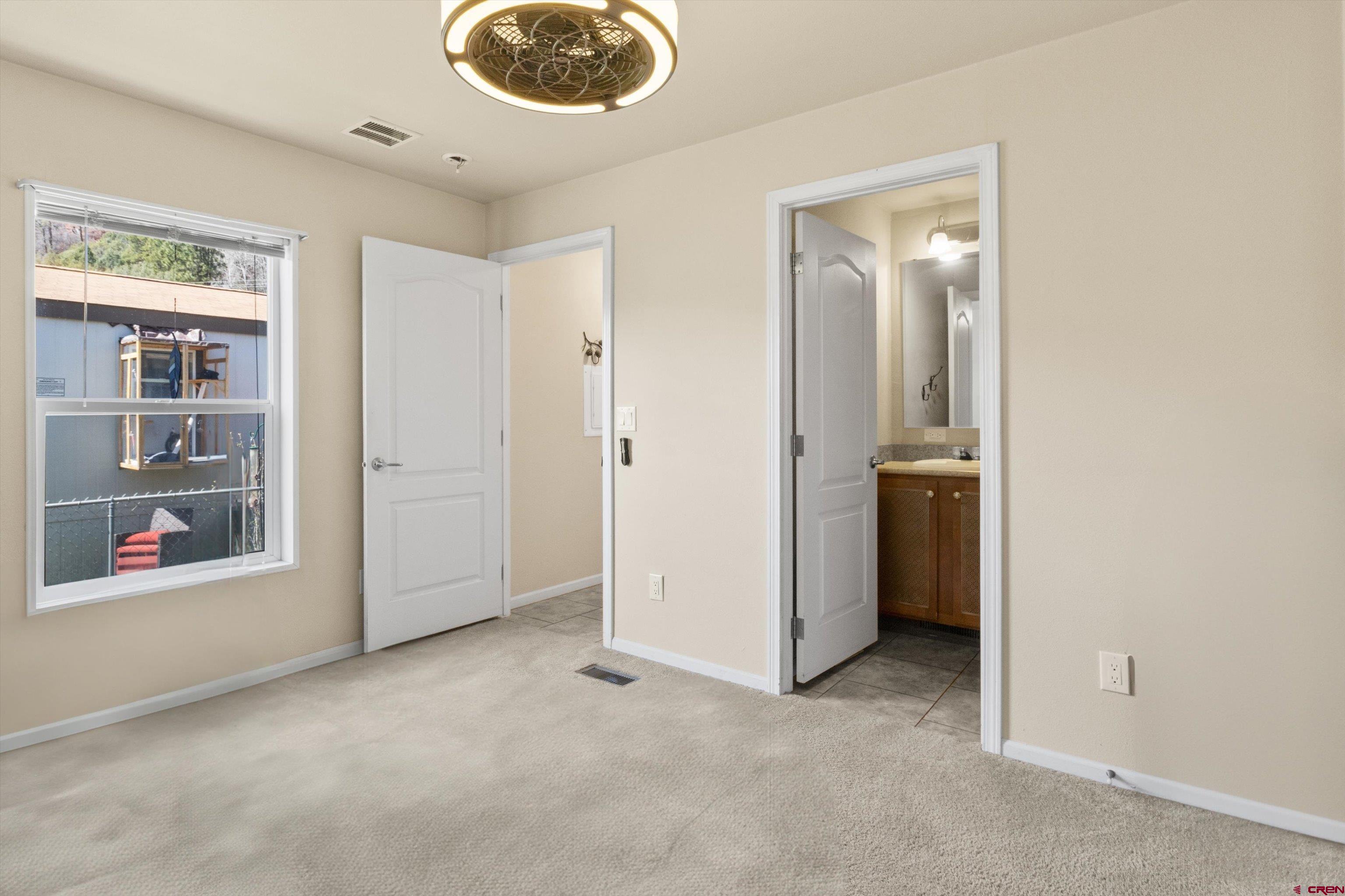 6000 County Road 203, Unit 34 Durango, CO 81301 - Photo 6 of 33 an empty room with closet and windows