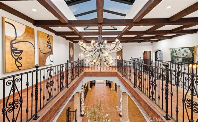 a living room with furniture flowerpot and a chandelier