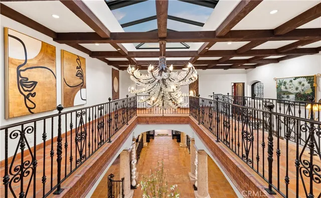 a living room with furniture flowerpot and a chandelier