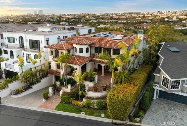 an aerial view of multiple houses with a yard