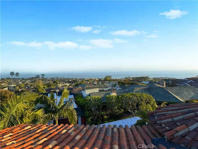 a bedroom with a bed and a large window with the outer view