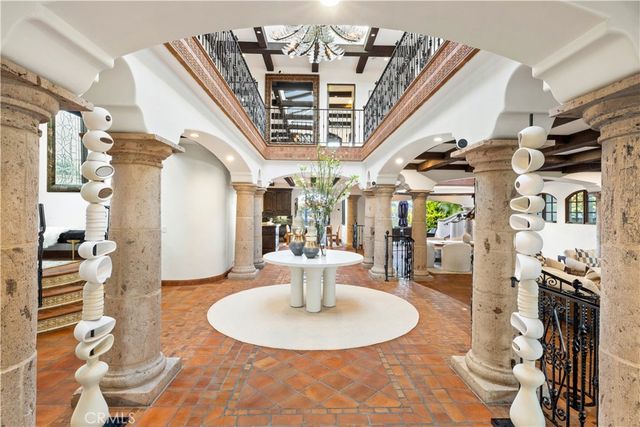a living room with furniture a flat screen tv and a floor to ceiling window