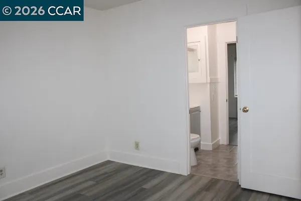 a view of a room with wooden floor