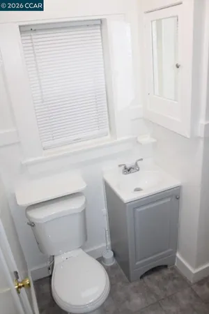 a white toilet sitting next to a bathroom sink