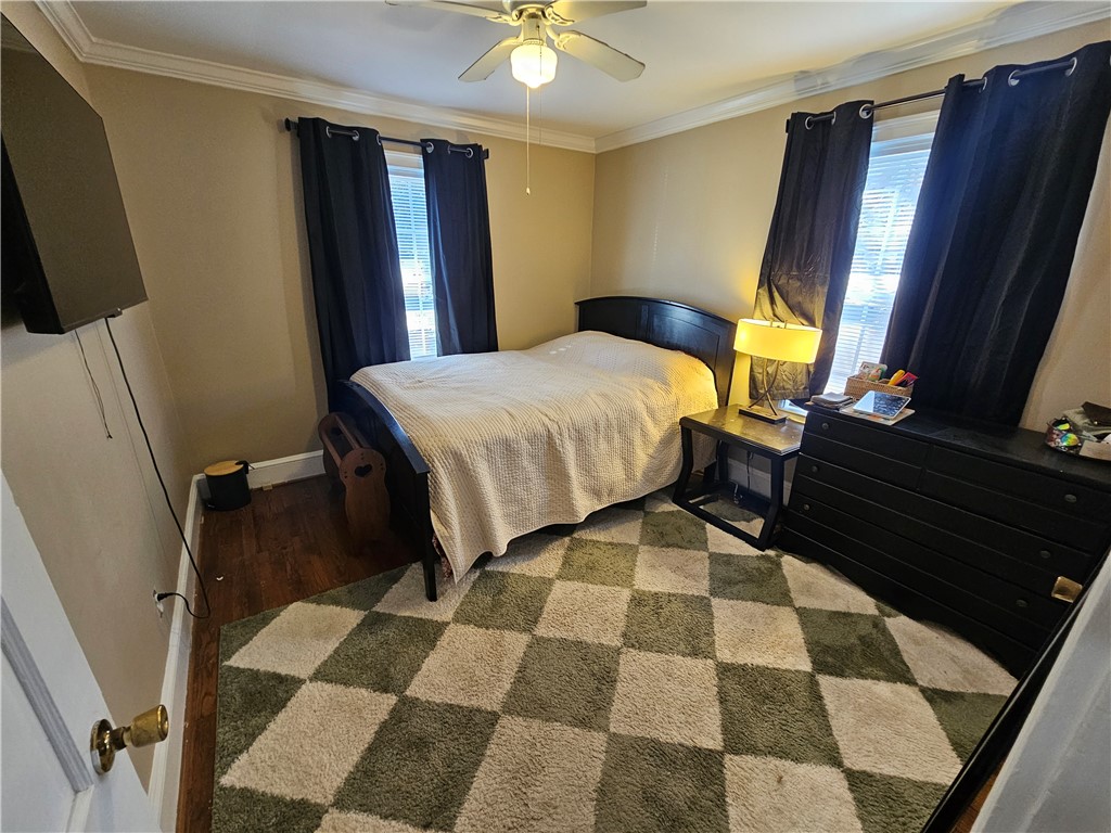 237 Pine Lane Anderson, SC 29621 - Photo 15 of 22 This cozy bedroom features warm wood flooring and elegant crown molding.