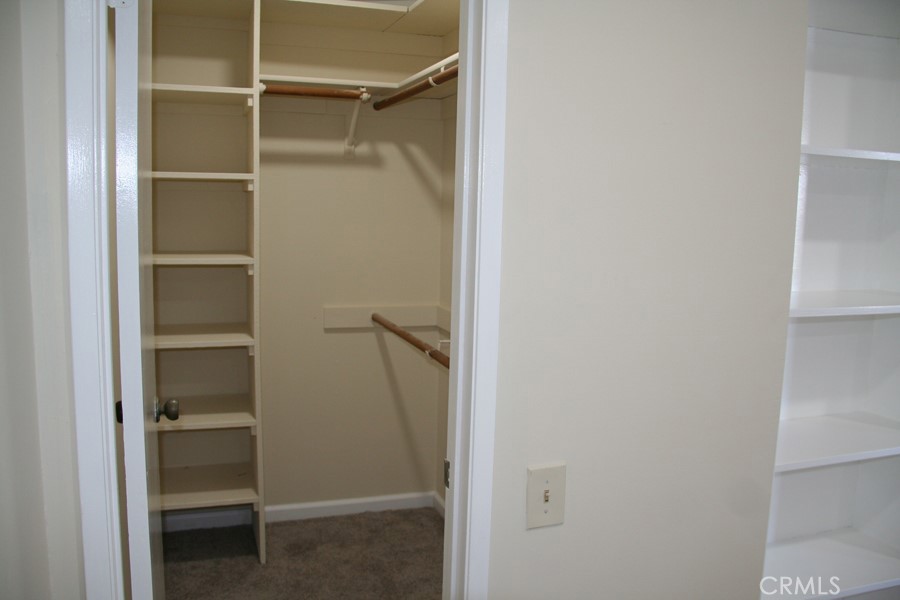 17140 Bluewater Lane, Unit 154 Huntington Beach, CA 92649 - Photo 11 of 28 a view of walk in closet with empty racks