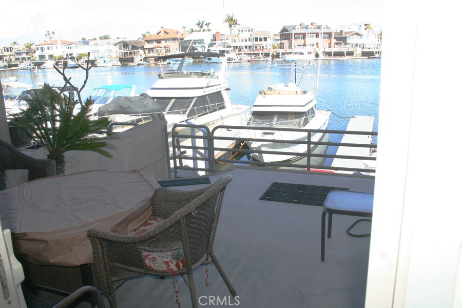 17140 Bluewater Lane, Unit 154 Huntington Beach, CA 92649 - Photo 19 of 28 a balcony with a table and chairs
