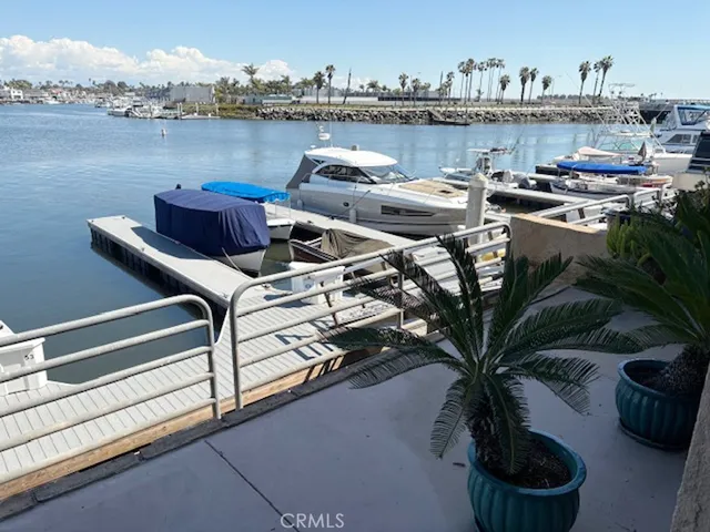 a terrace of a house with outdoor seating and lake view