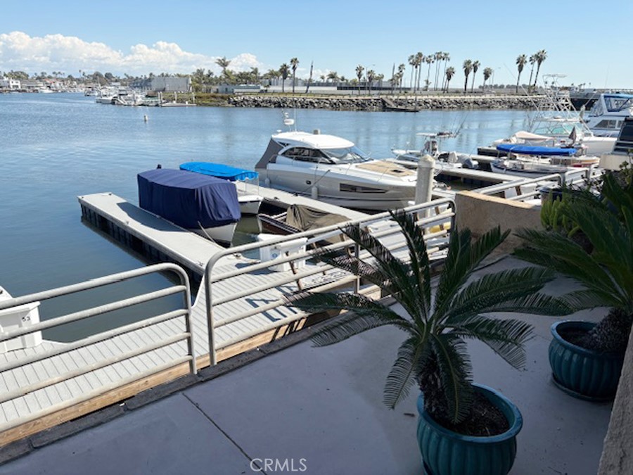 17140 Bluewater Lane, Unit 154 Huntington Beach, CA 92649 - Photo 22 of 28 a terrace of a house with outdoor seating and lake view