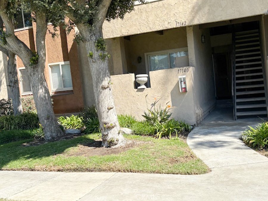17140 Bluewater Lane, Unit 154 Huntington Beach, CA 92649 - Photo 23 of 28 a side view of a house with a yard