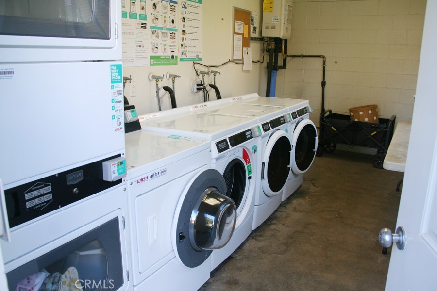 17140 Bluewater Lane, Unit 154 Huntington Beach, CA 92649 - Photo 24 of 28 a utility room with dryer and washer