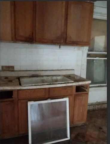 a stove top oven sitting inside of a kitchen
