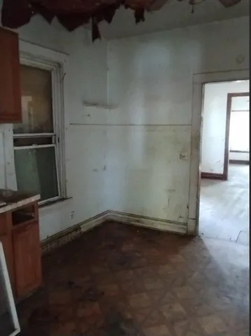 a view of a room with wooden floor and a fireplace