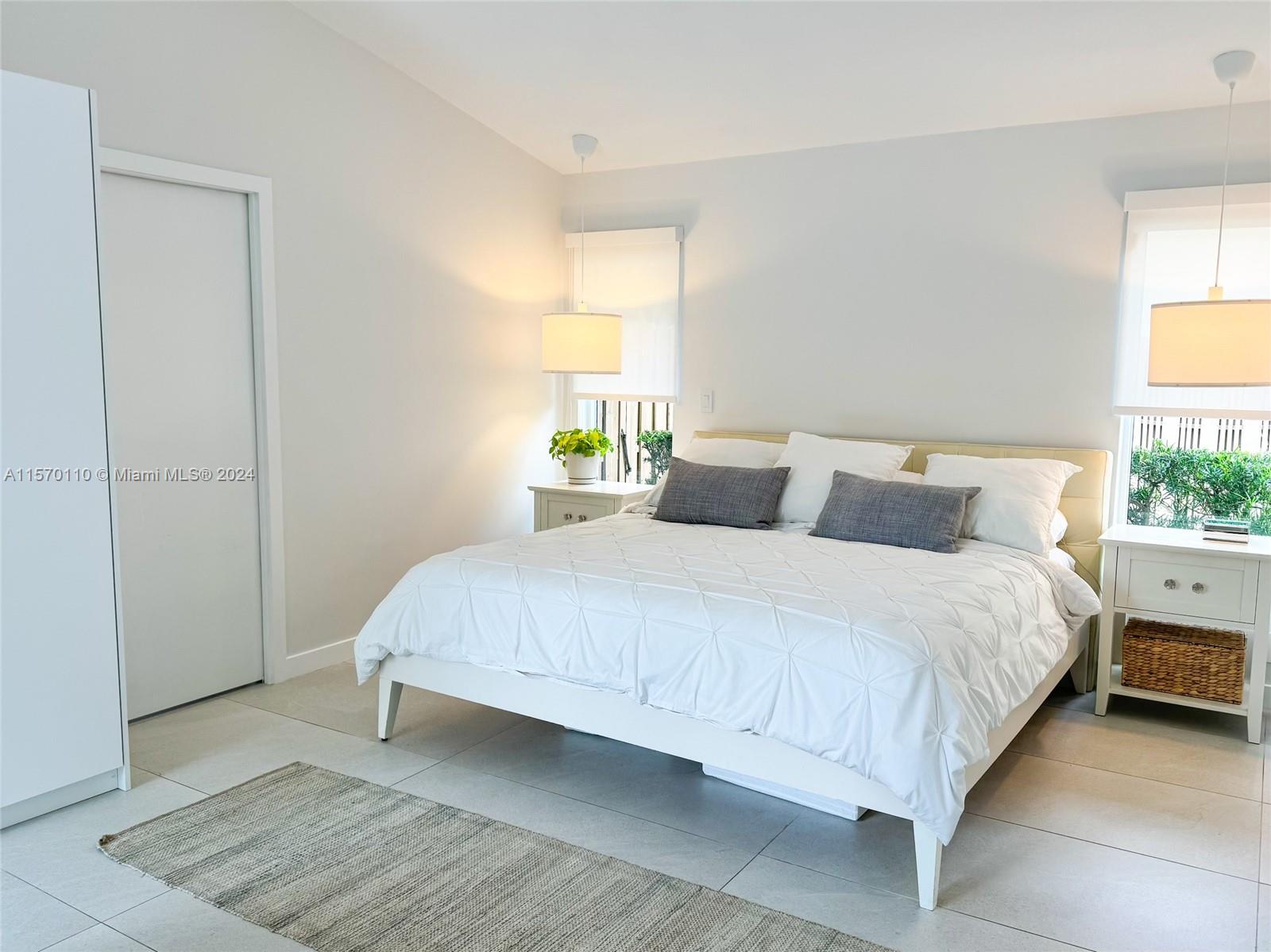 1945 Lakeshore Drive Weston, FL 33326 - Photo 11 of 19 a bedroom with a bed and window