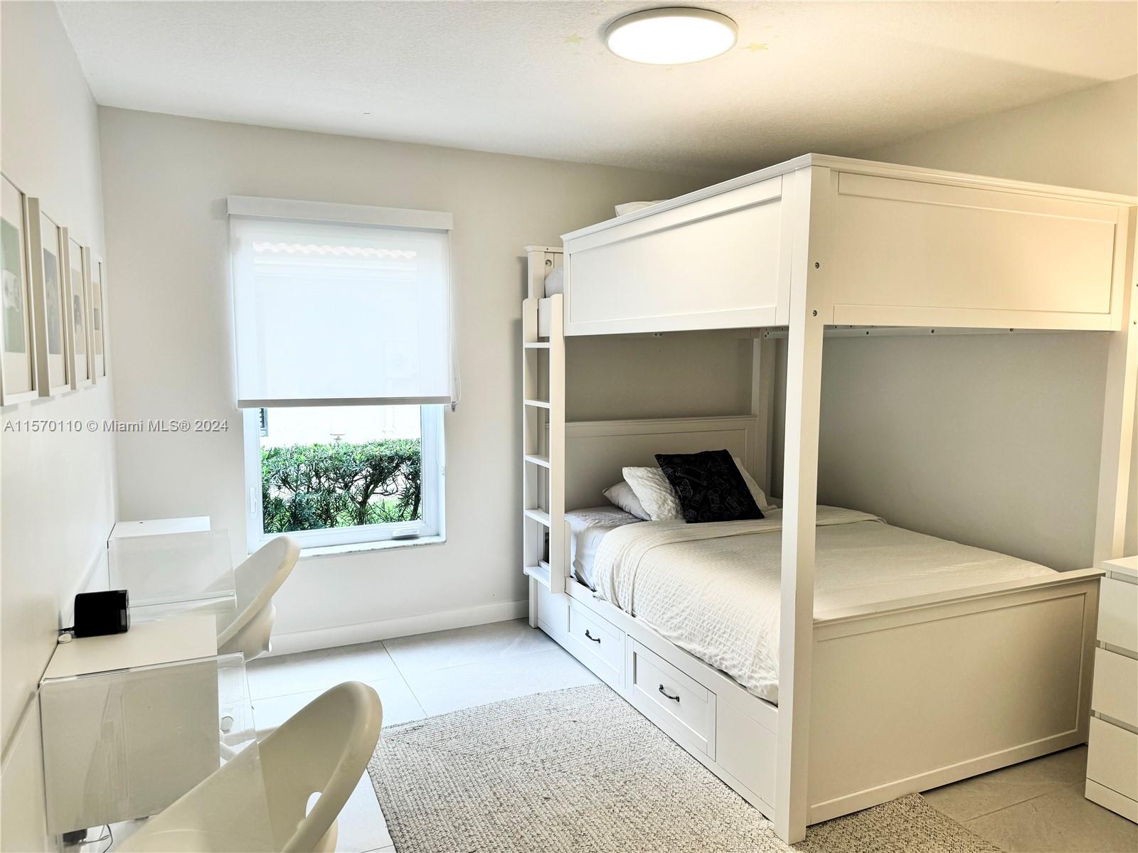 1945 Lakeshore Drive Weston, FL 33326 - Photo 15 of 19 a bedroom with a bed and a window