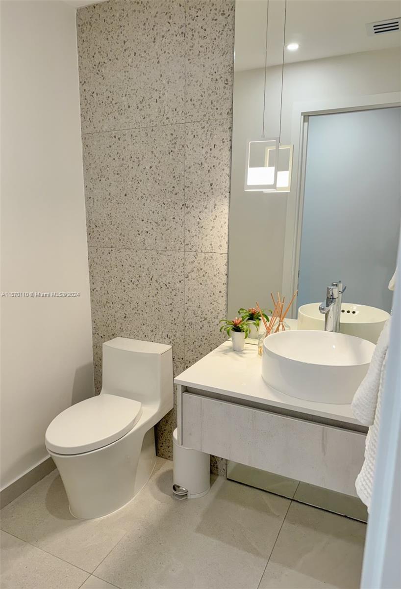 1945 Lakeshore Drive Weston, FL 33326 - Photo 18 of 19 a bathroom with a sink a toilet and mirror