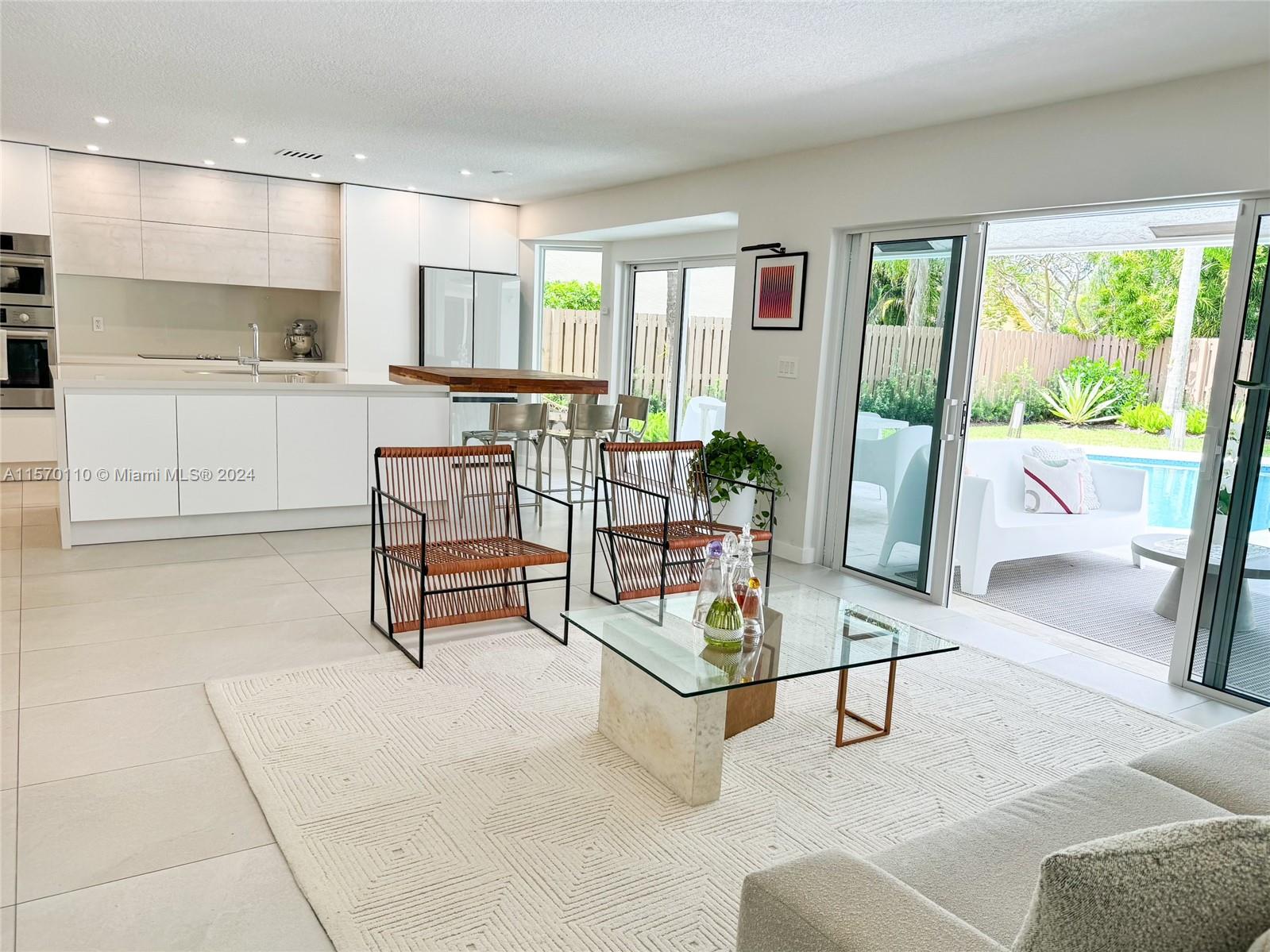 1945 Lakeshore Drive Weston, FL 33326 - Photo 7 of 19 a living room with furniture and a table