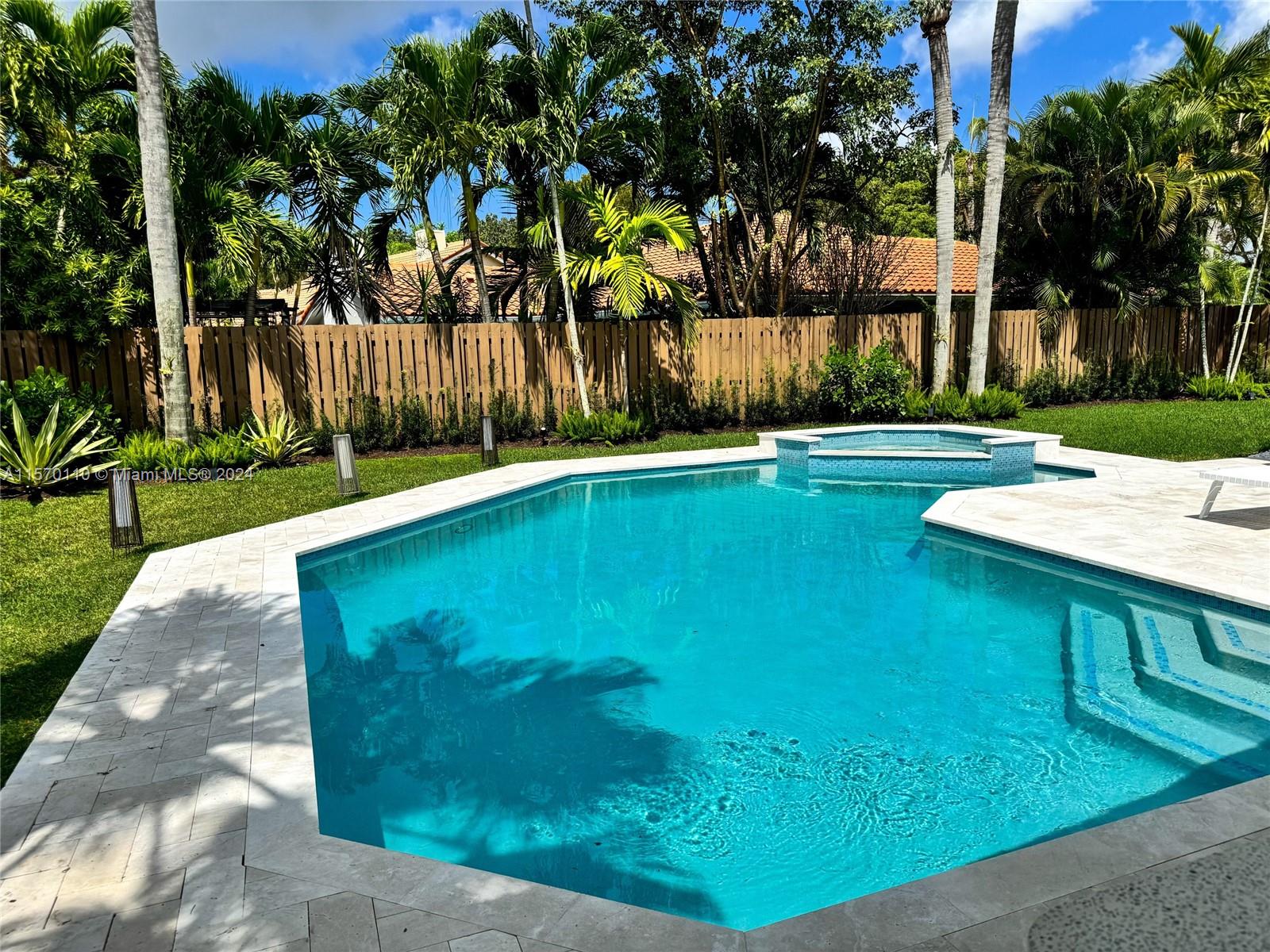 1945 Lakeshore Drive Weston, FL 33326 - Photo 9 of 19 a view of a swimming pool with a bench and trees