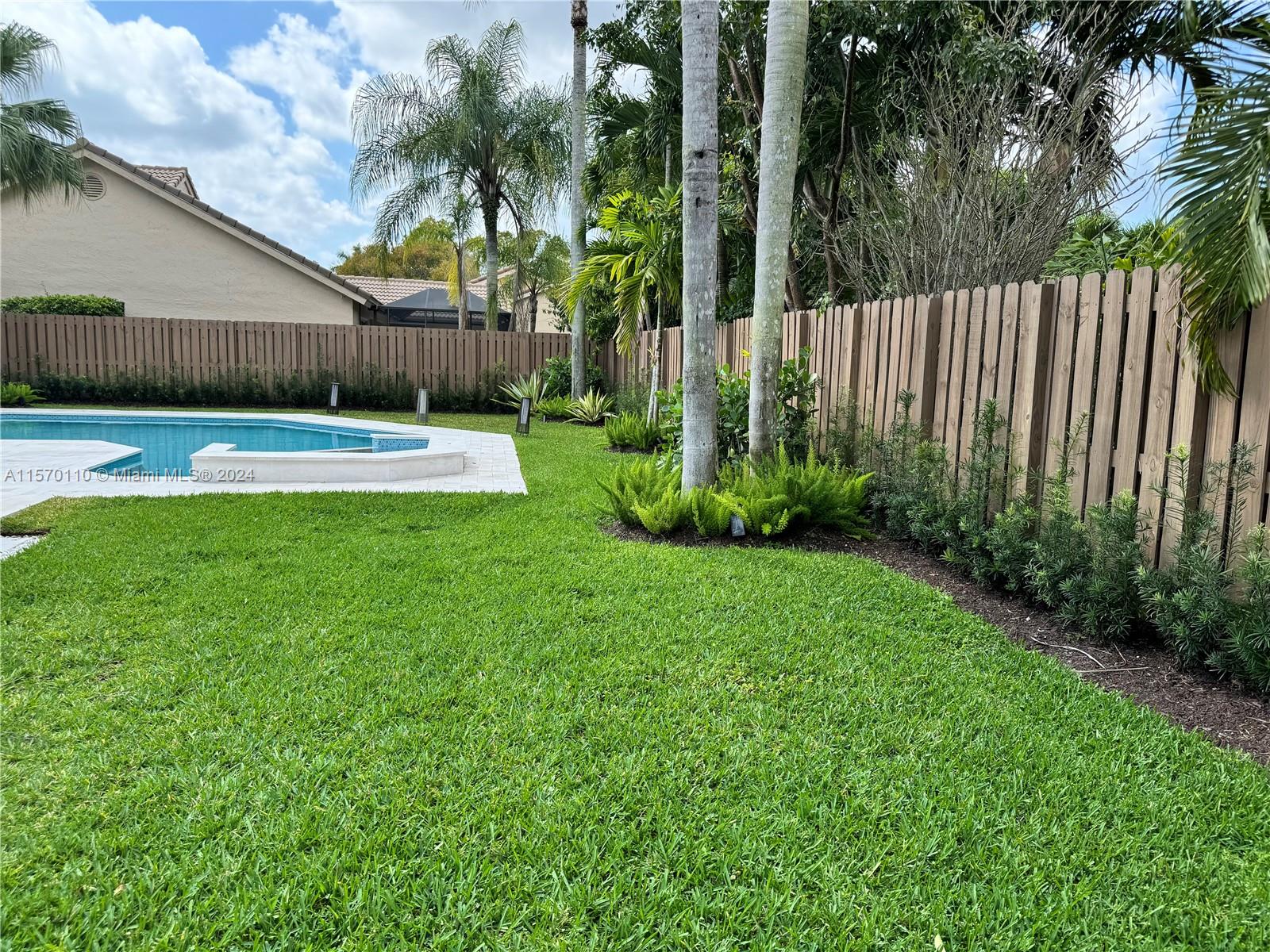 1945 Lakeshore Drive Weston, FL 33326 - Photo 10 of 19 a view of a garden with palm trees