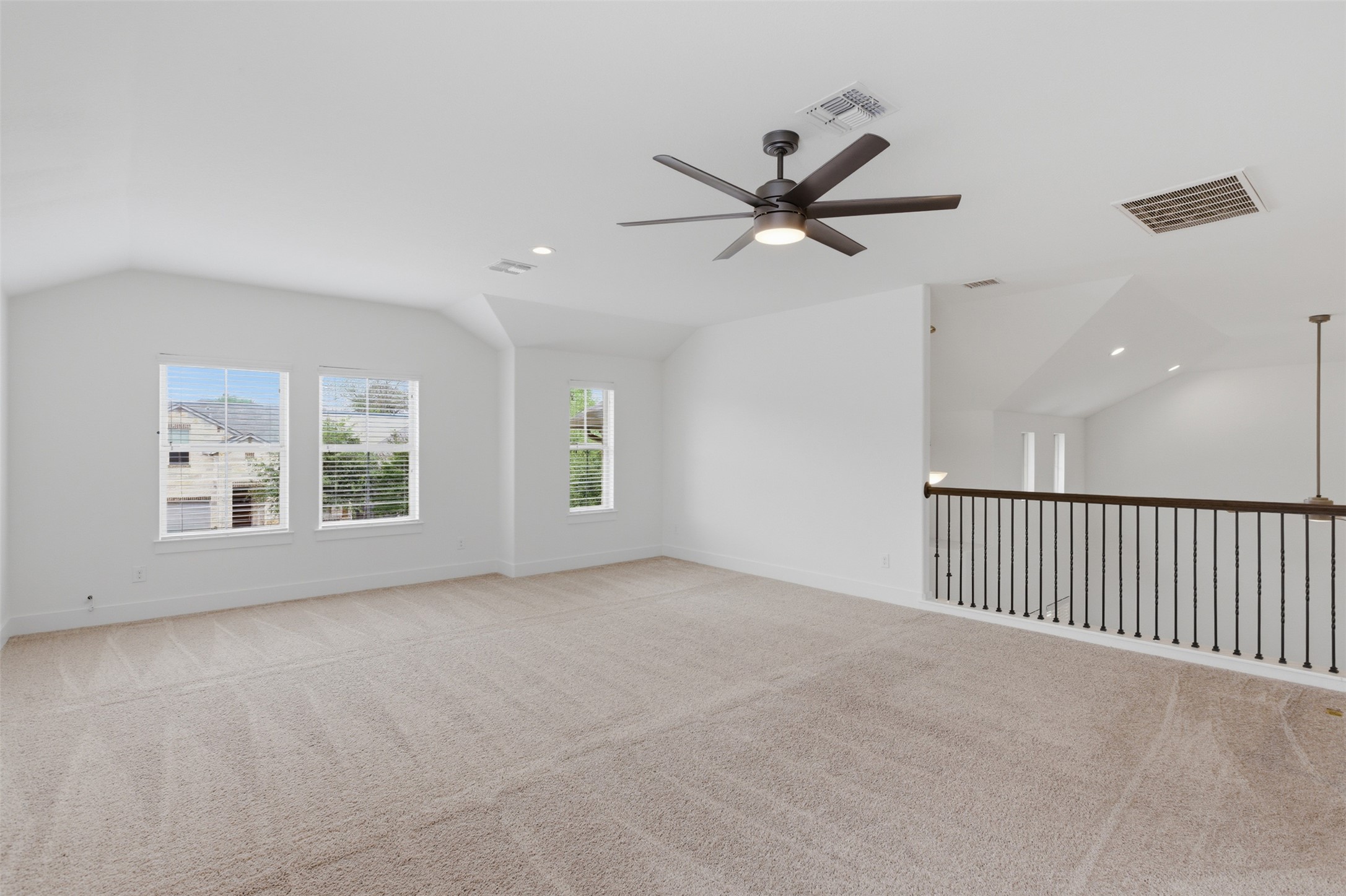 2004 Garretts Way Manchaca, TX 78652 - Photo 15 of 24 Unfurnished room with vaulted ceiling, carpet flooring, ceiling fan, and recessed lighting
