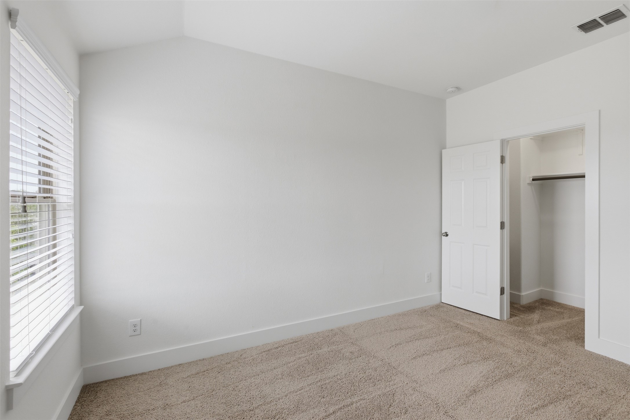 2004 Garretts Way Manchaca, TX 78652 - Photo 16 of 24 Unfurnished bedroom featuring light carpet and baseboards