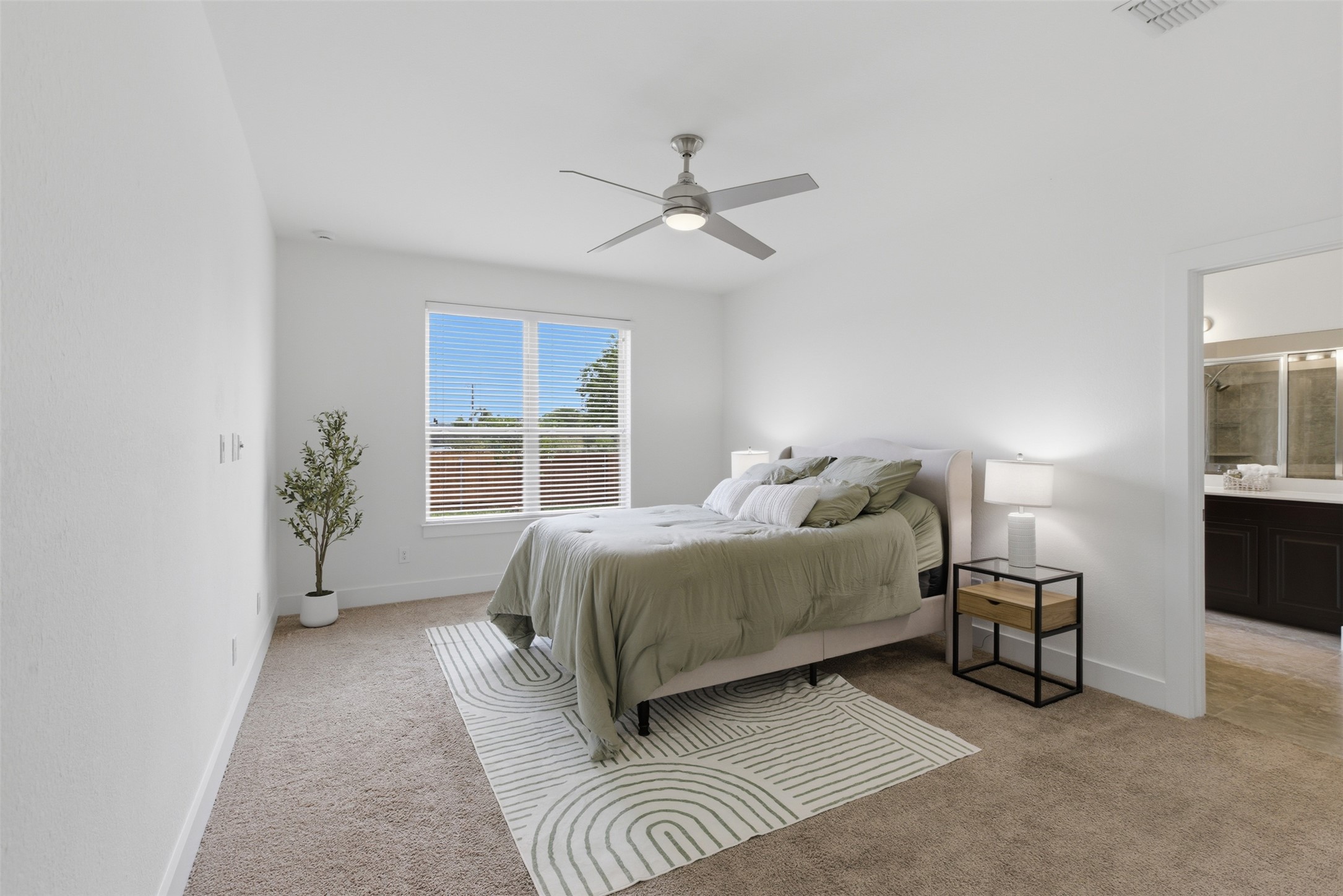 2004 Garretts Way Manchaca, TX 78652 - Photo 17 of 37 The property features a bright bedroom with carpet flooring, a ceiling fan, and a window with blinds