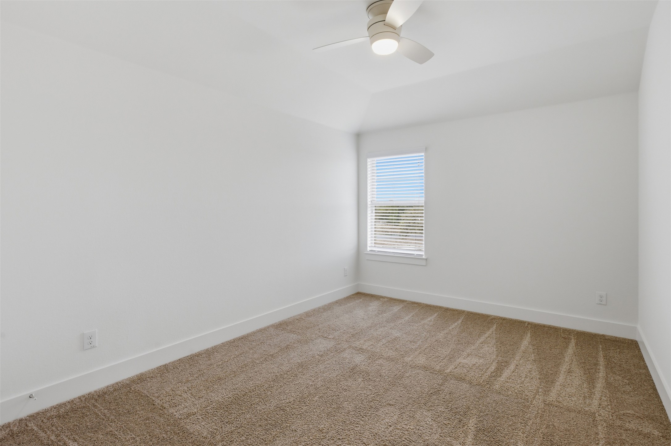 2004 Garretts Way Manchaca, TX 78652 - Photo 18 of 24 Unfurnished room with light carpet, ceiling fan, and lofted ceiling