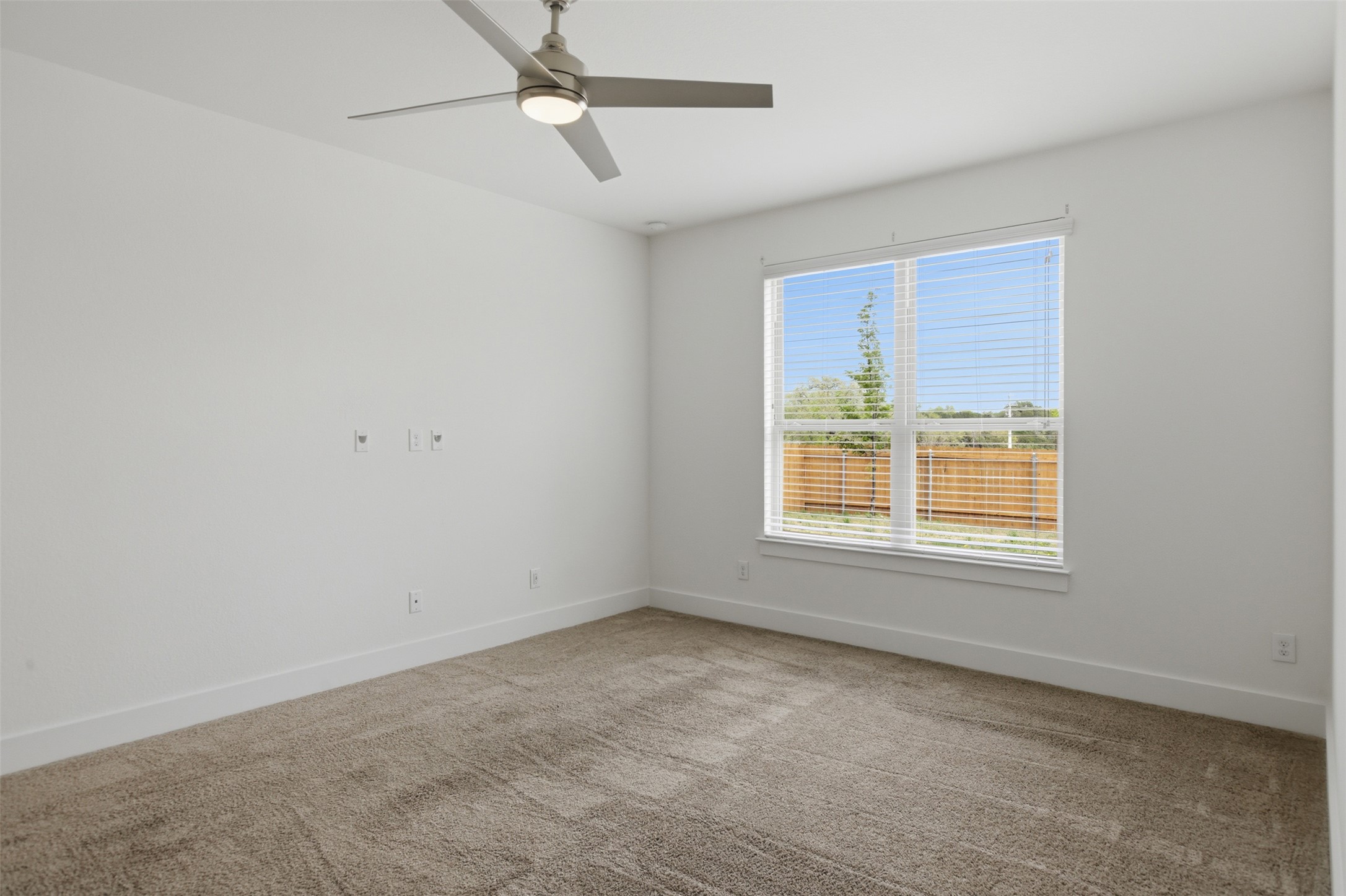 2004 Garretts Way Manchaca, TX 78652 - Photo 19 of 37 Carpeted primary room with baseboards and a ceiling fan
