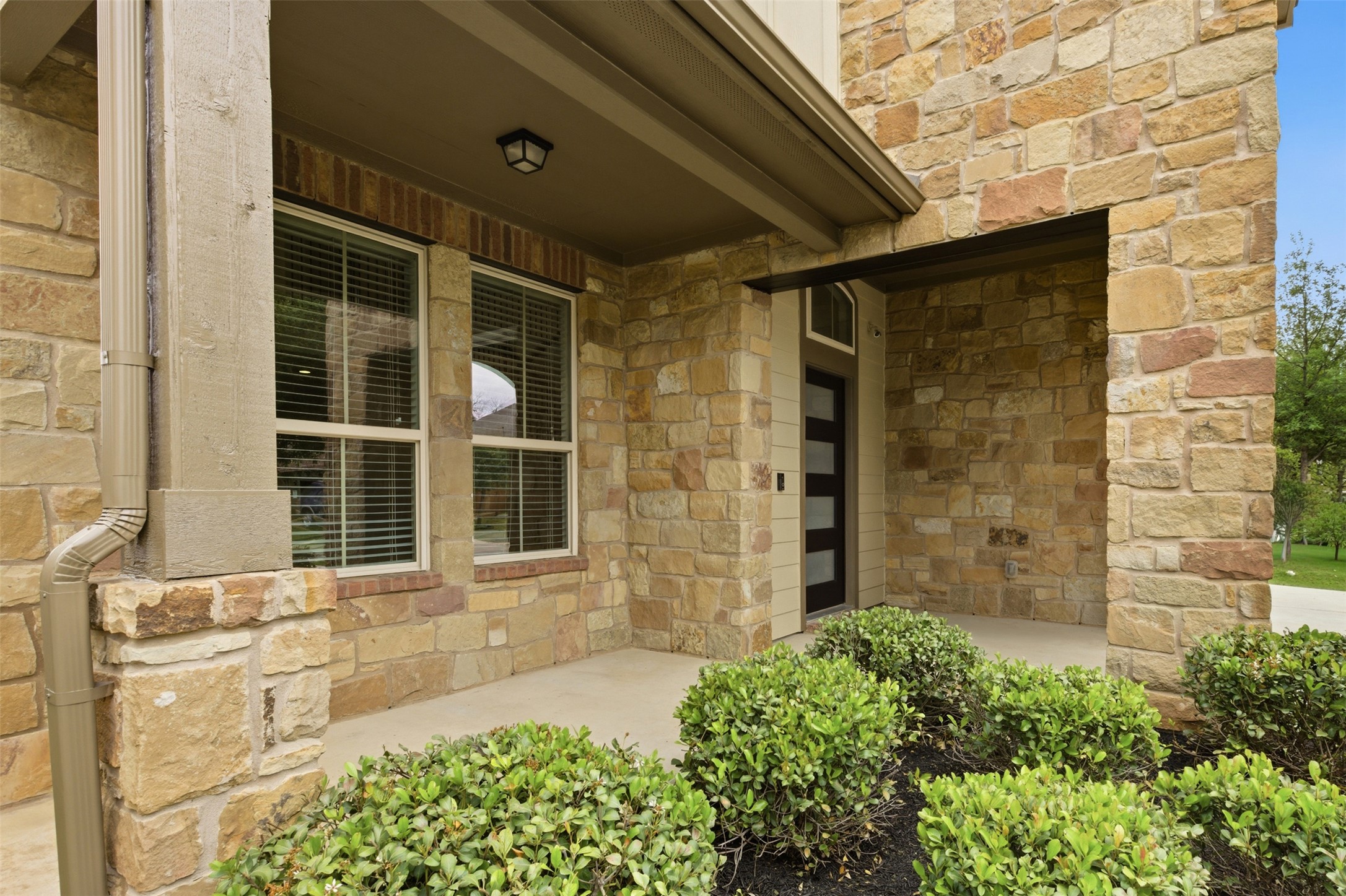 2004 Garretts Way Manchaca, TX 78652 - Photo 2 of 24 Entrance to property with stone siding and covered porch