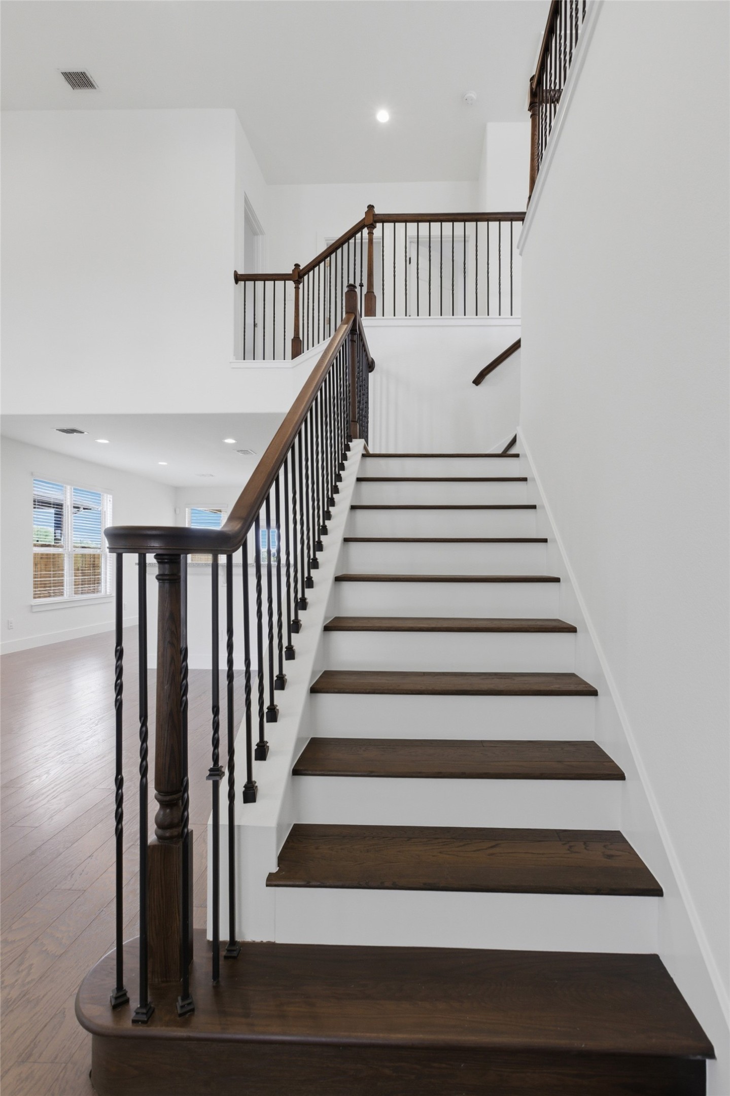 2004 Garretts Way Manchaca, TX 78652 - Photo 21 of 37 Staircase featuring a high ceiling, wood finished floors, and recessed lighting