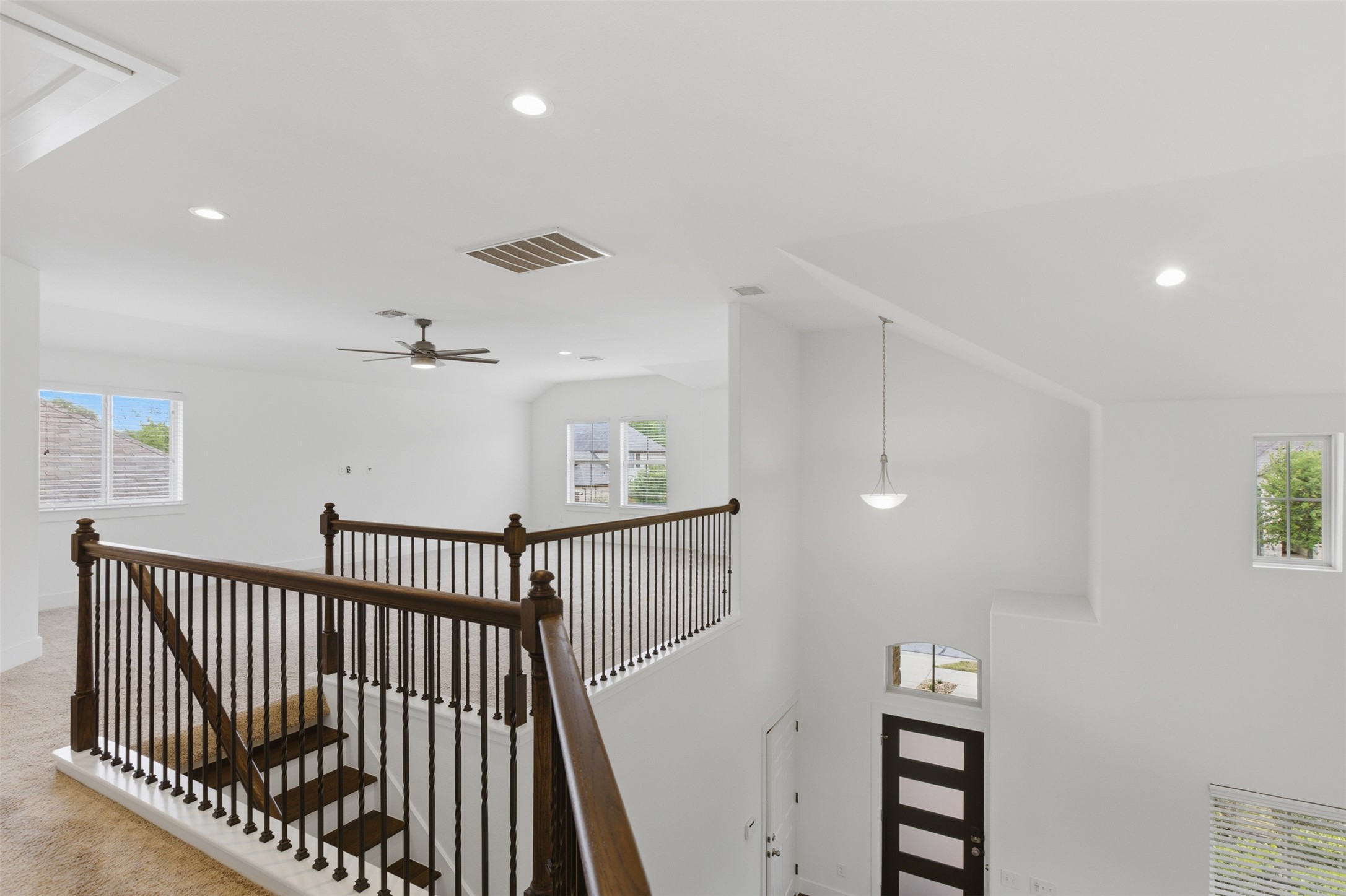 2004 Garretts Way Manchaca, TX 78652 - Photo 22 of 37 Hallway with an upstairs landing, recessed lighting, plenty of natural light, and a high ceiling