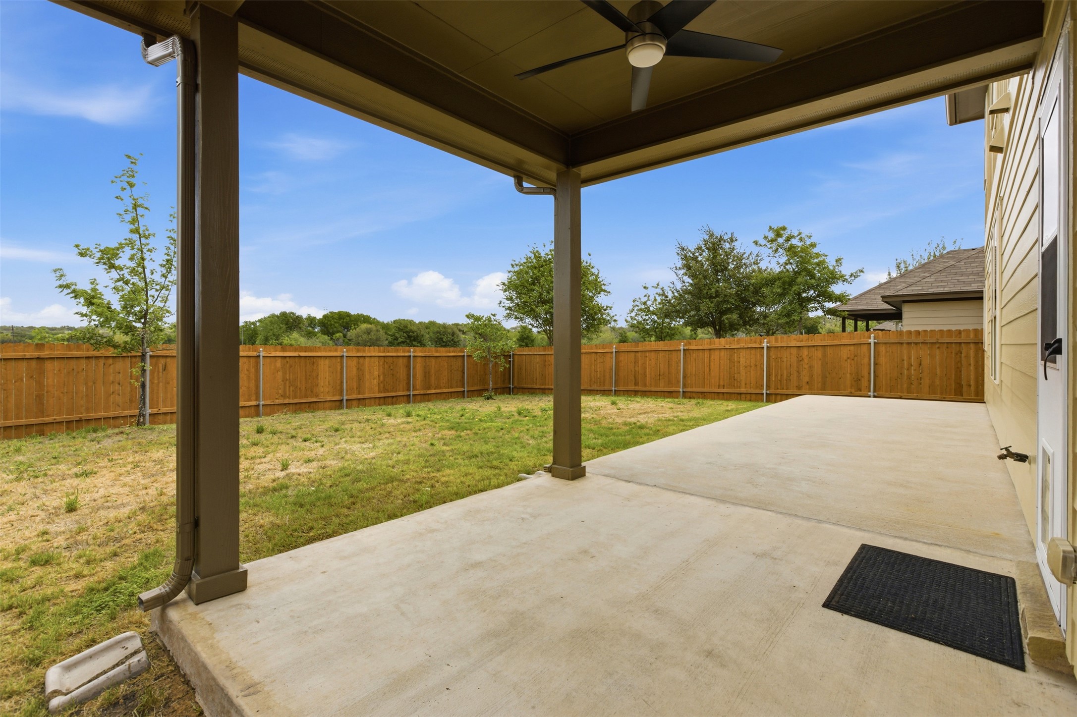 2004 Garretts Way Manchaca, TX 78652 - Photo 36 of 37 Fenced backyard with a patio and ceiling fan