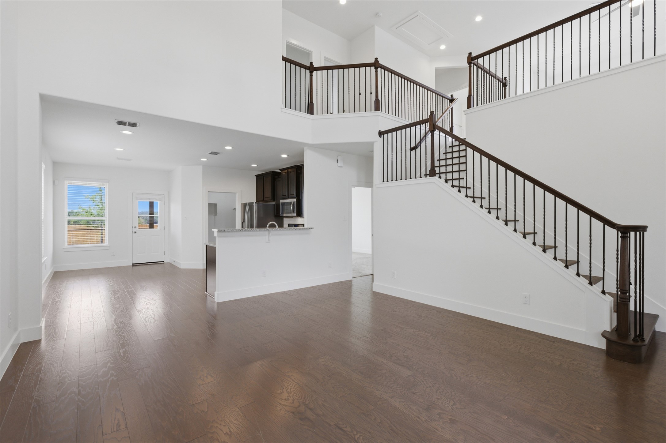 2004 Garretts Way Manchaca, TX 78652 - Photo 4 of 24 Unfurnished living room featuring recessed lighting and dark wood finished floors