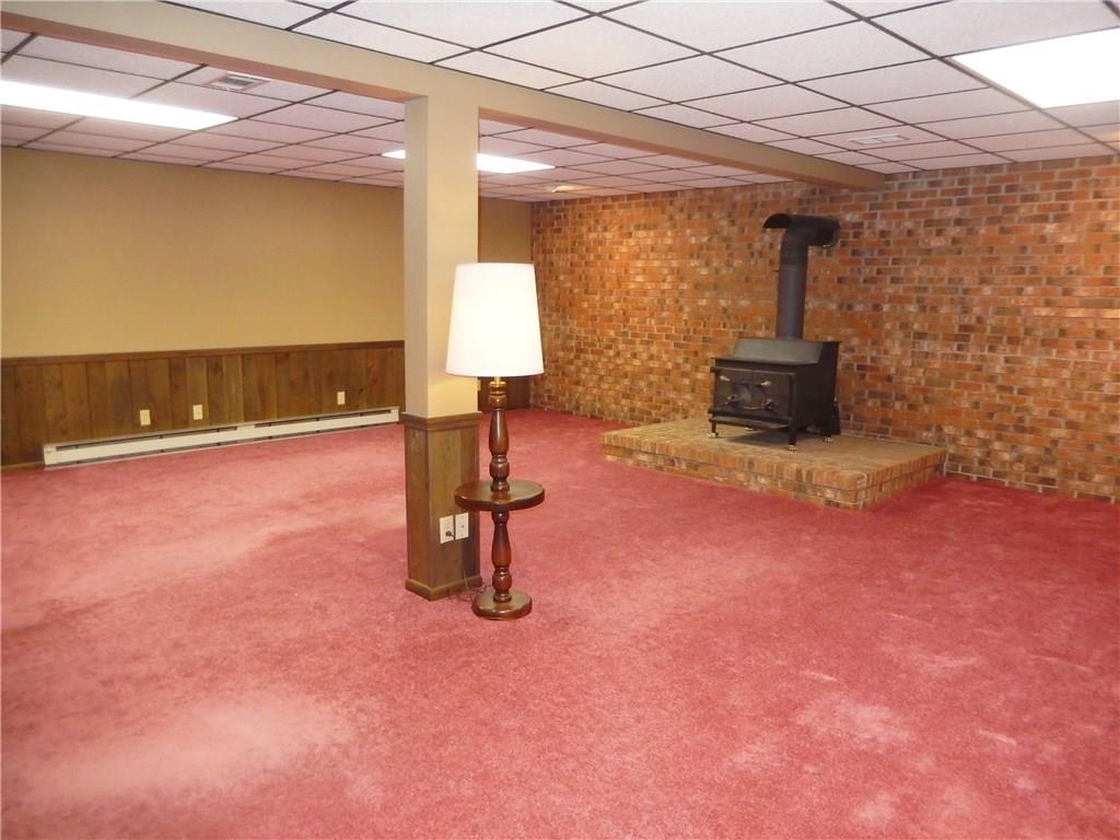 2107 Rocky Ridge Road Acme, PA 15610 - Photo 16 of 25 Finished lower level game room with wood burner is ideal for cozy nights by the fire enjoying your favorite shows or having game night