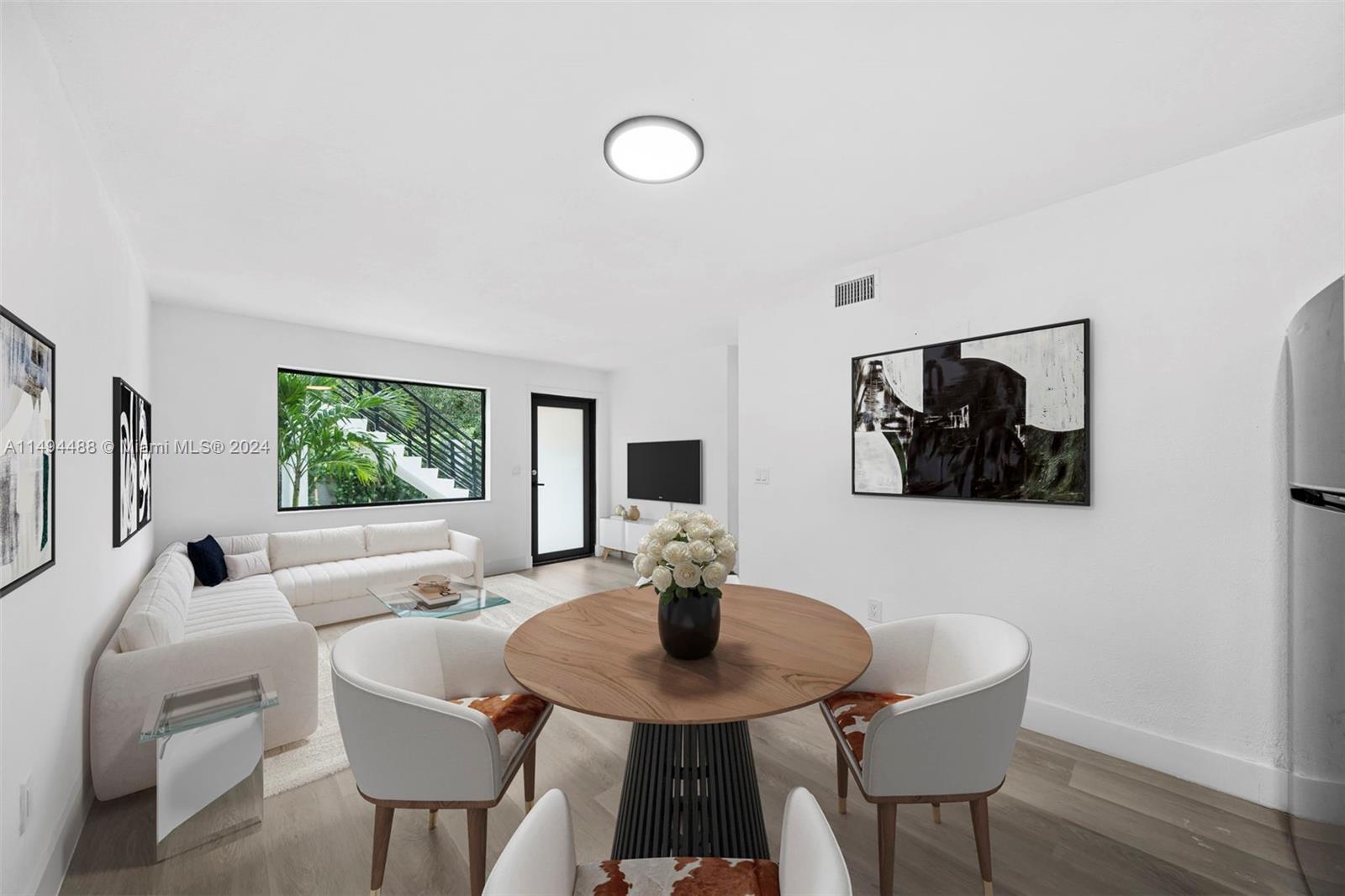 a view of a dining room with furniture and wooden floor