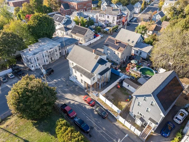 an aerial view of a house with a yard