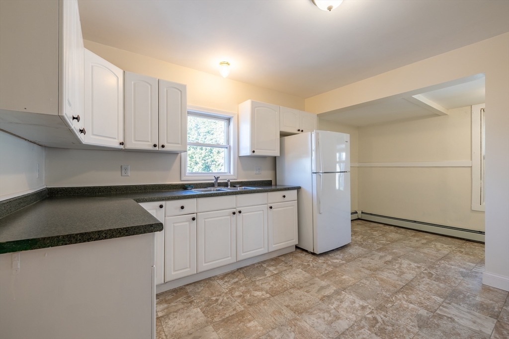 15 Rose Street, Unit 2 Haverhill, MA 01830 - Photo 5 of 15 a kitchen with a refrigerator and cabinets